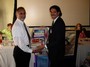 Principal Frank Ohesorgan, Beamer School, accepts a donation of books from the club, for national literacy day.